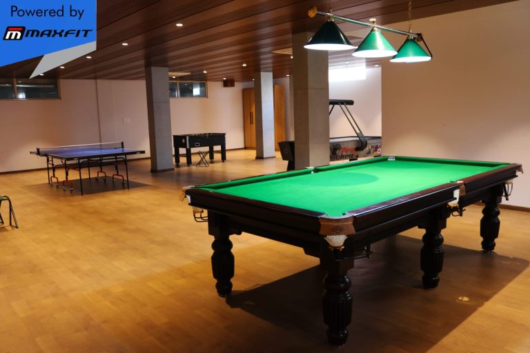 Ananda Bay Hills clubhouse featuring Maxfit commercial gym equipment, indoor games and outdoor play area by Maxfit Equipment Solutions in Narsingi, Hyderabad.